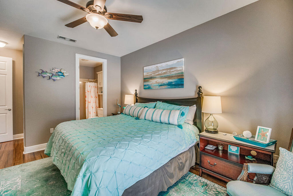 2655 Masters Boulevard Navarre, FL 32566 - Photo 42 of 87 a bedroom with a bed and a chandelier