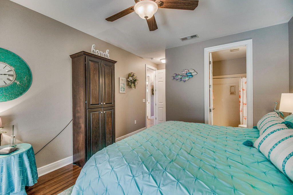 2655 Masters Boulevard Navarre, FL 32566 - Photo 43 of 87 a bedroom with a large bed and a chandelier