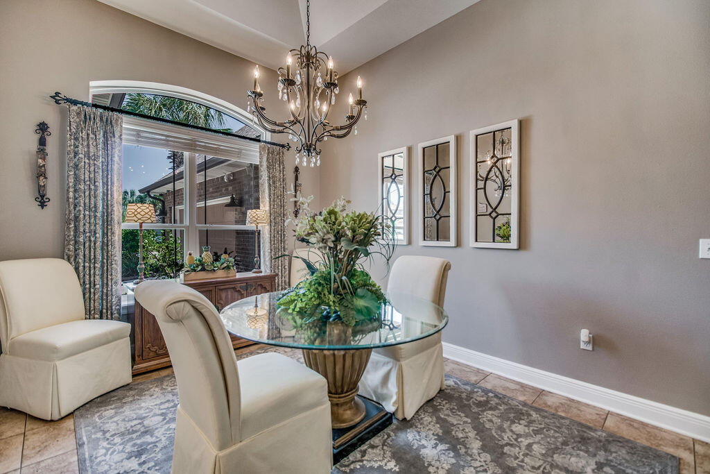 2655 Masters Boulevard Navarre, FL 32566 - Photo 5 of 87 a dining room with furniture a livingroom and chandelier