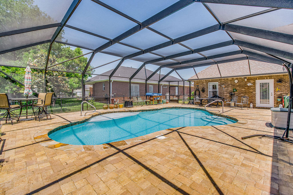 2655 Masters Boulevard Navarre, FL 32566 - Photo 51 of 87 a view of a swimming pool with a patio