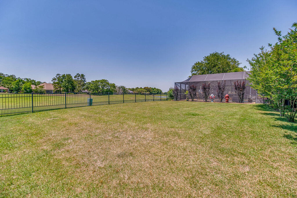 2655 Masters Boulevard Navarre, FL 32566 - Photo 58 of 87 a view of a green field with wooden fence