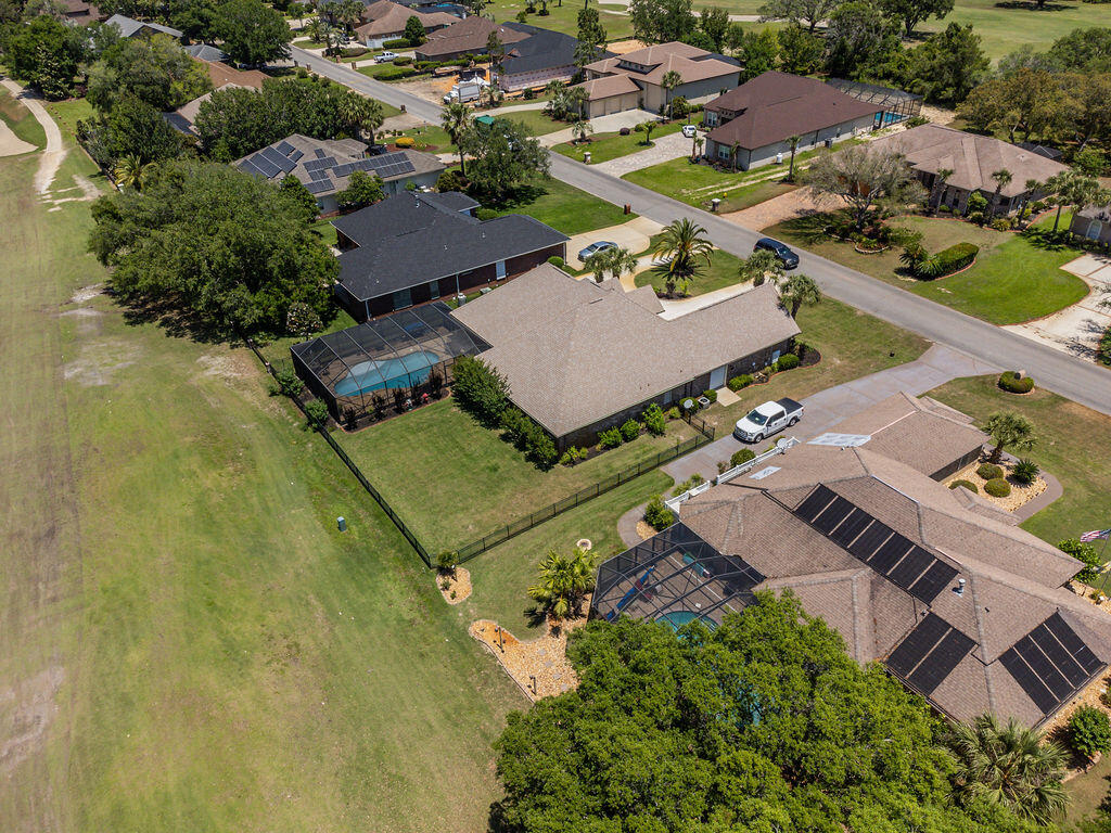 2655 Masters Boulevard Navarre, FL 32566 - Photo 61 of 87 an aerial view of a house with a swimming pool