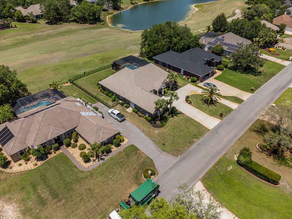 2655 Masters Boulevard Navarre, FL 32566 - Photo 62 of 87 an aerial view of a house with garden space