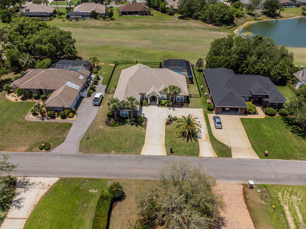 2655 Masters Boulevard Navarre, FL 32566 - Photo 63 of 87 an aerial view of a house with outdoor space