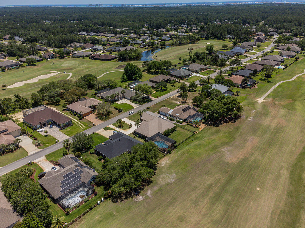 2655 Masters Boulevard Navarre, FL 32566 - Photo 65 of 87 an aerial view of residential houses with outdoor space and river