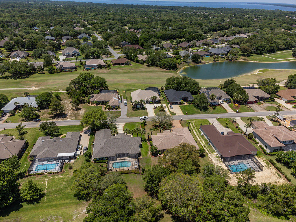 2655 Masters Boulevard Navarre, FL 32566 - Photo 73 of 87 an aerial view of residential houses with outdoor space and river