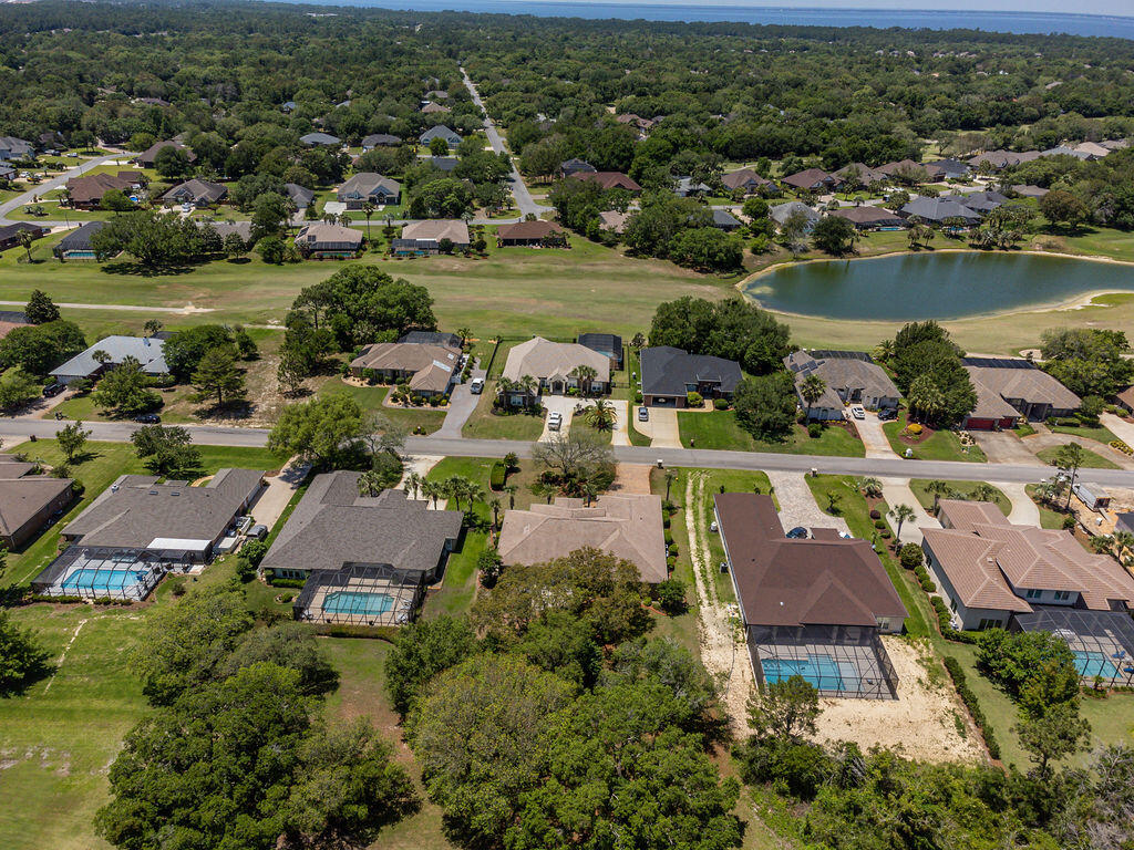 2655 Masters Boulevard Navarre, FL 32566 - Photo 74 of 87 an aerial view of residential house with outdoor space and lake view