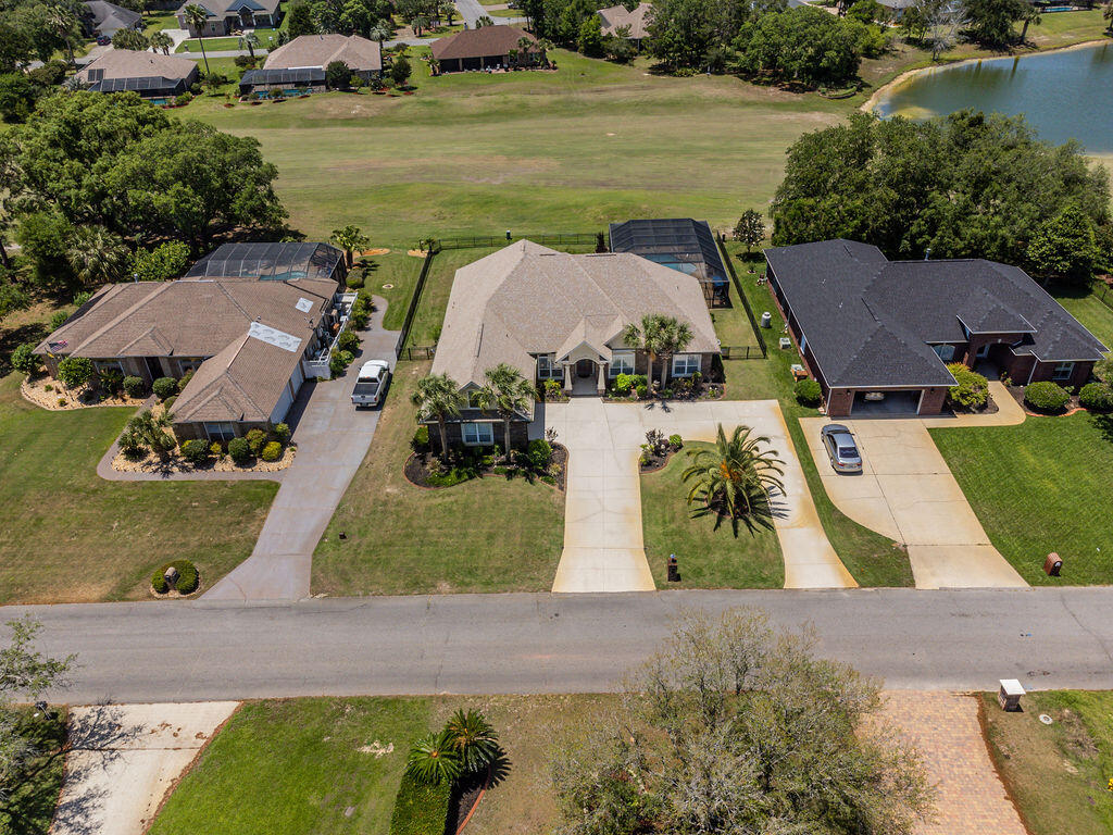 2655 Masters Boulevard Navarre, FL 32566 - Photo 76 of 87 an aerial view of residential houses with outdoor space and swimming pool