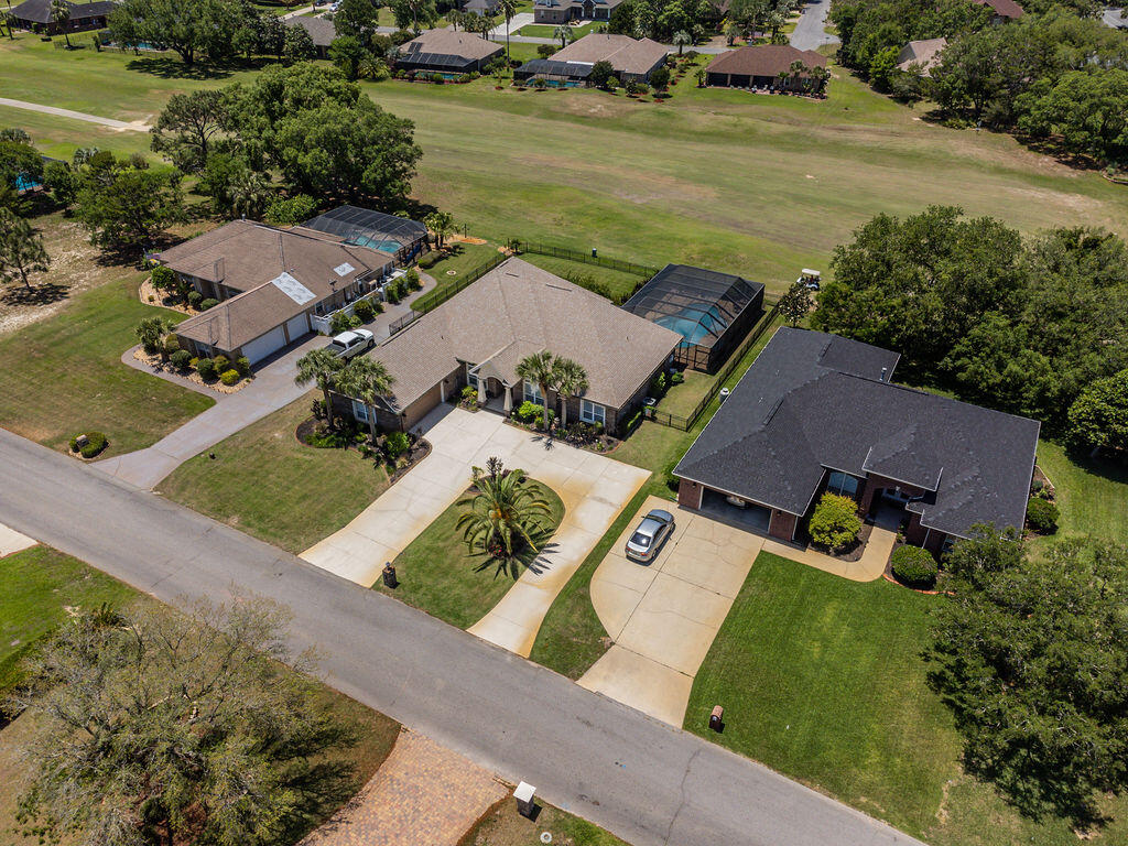 2655 Masters Boulevard Navarre, FL 32566 - Photo 77 of 87 an aerial view of a house with a garden and lake view