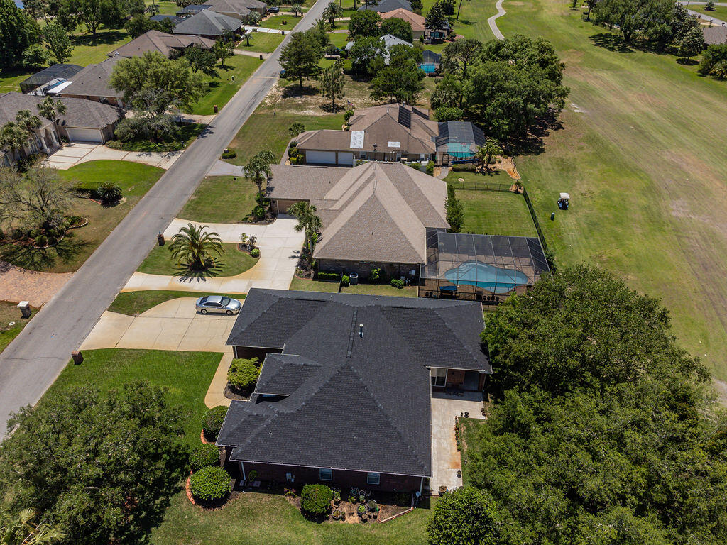 2655 Masters Boulevard Navarre, FL 32566 - Photo 79 of 87 an aerial view of a house with a garden