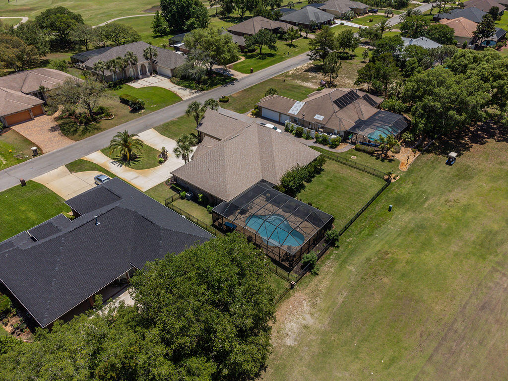 2655 Masters Boulevard Navarre, FL 32566 - Photo 80 of 87 an aerial view of a house with a yard