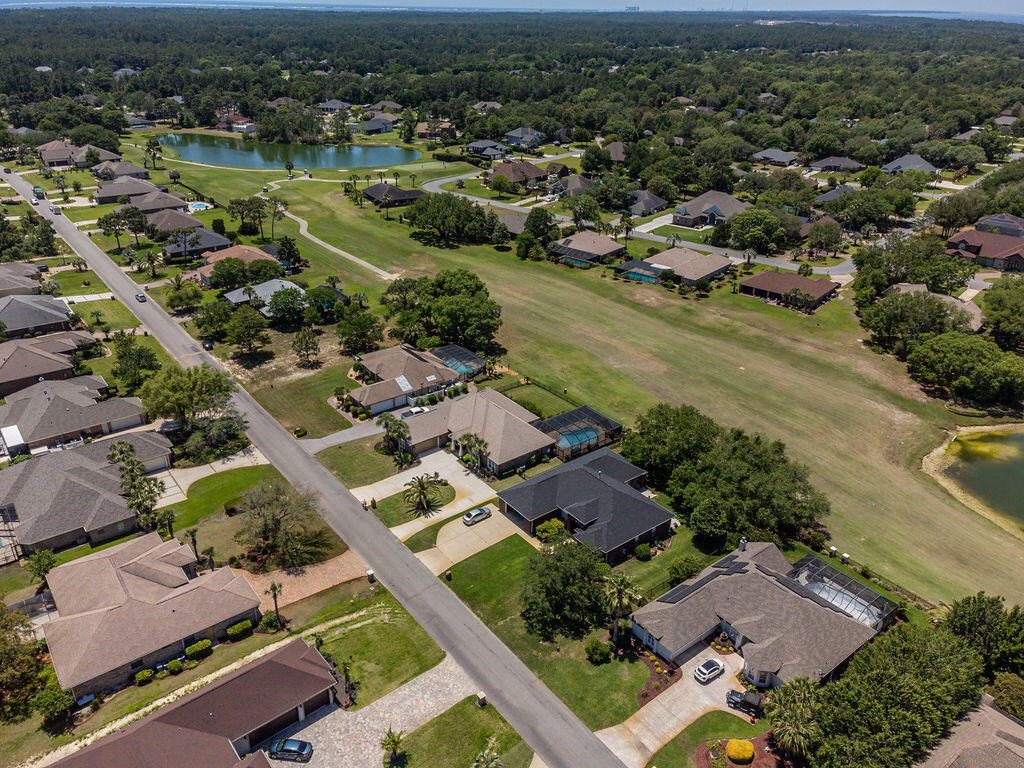 2655 Masters Boulevard Navarre, FL 32566 - Photo 84 of 87 an aerial view of residential houses with outdoor space