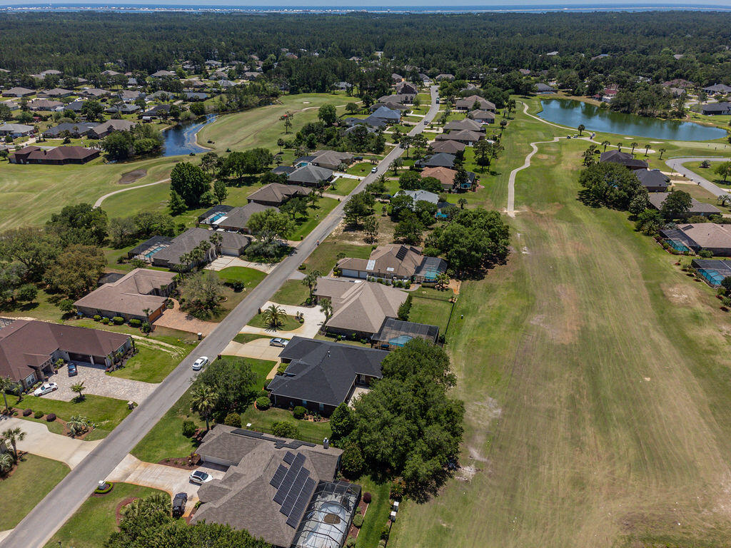 2655 Masters Boulevard Navarre, FL 32566 - Photo 85 of 87 an aerial view of residential houses with outdoor space and river