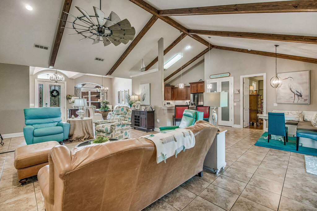 2655 Masters Boulevard Navarre, FL 32566 - Photo 9 of 87 a living room with furniture and a chandelier