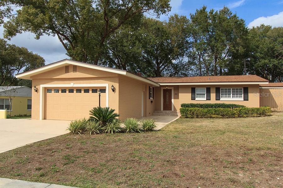 2803 Riddle Drive Winter Park, FL 32789 - Photo 1 of 1 a front view of house with yard and trees in the background
