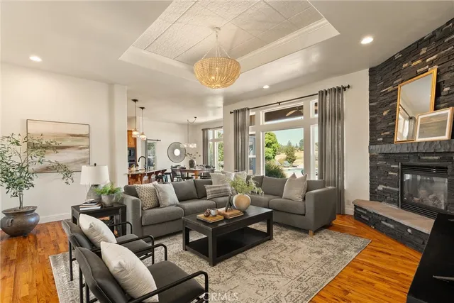 a living room with furniture wooden floor and a chandelier