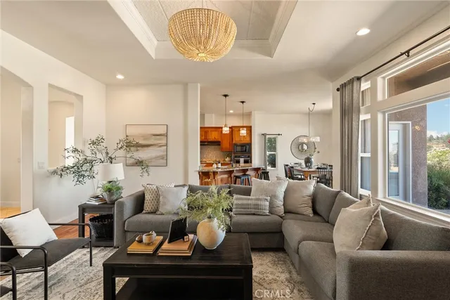a kitchen with kitchen island granite countertop a sink and a refrigerator