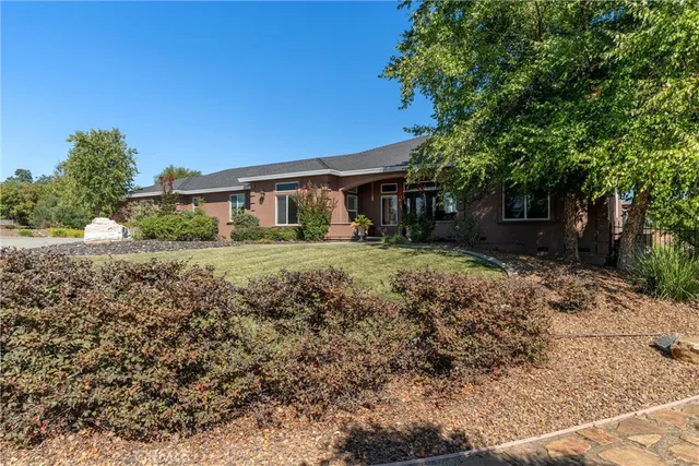 a front view of house with yard and outdoor seating