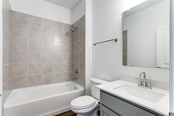 a bathroom with a bathtub toilet sink vanity and mirror