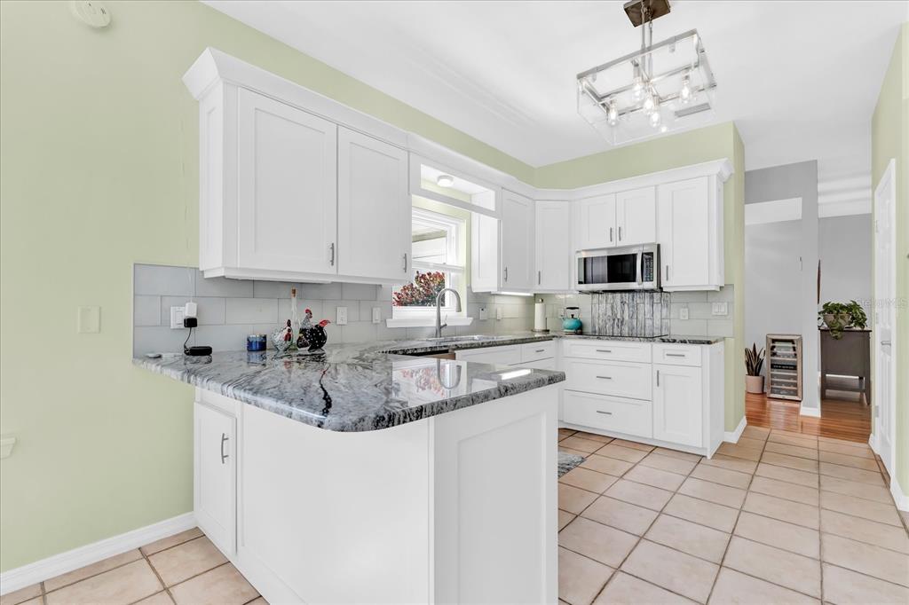 2 Bulow's Landing Flagler Beach, FL 32136 - Photo 11 of 42 a kitchen with stainless steel appliances granite countertop a sink a stove and cabinets