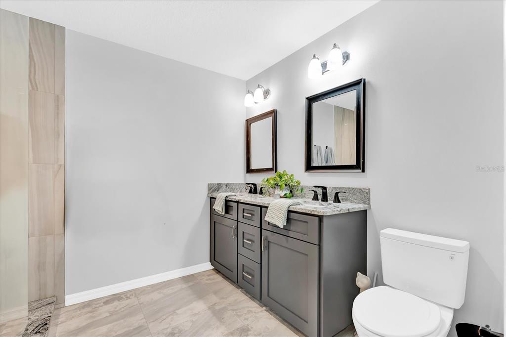 2 Bulow's Landing Flagler Beach, FL 32136 - Photo 19 of 42 a bathroom with a toilet a sink and mirror