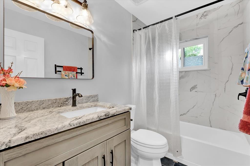2 Bulow's Landing Flagler Beach, FL 32136 - Photo 24 of 42 a bathroom with a granite countertop sink a toilet and a bathtub
