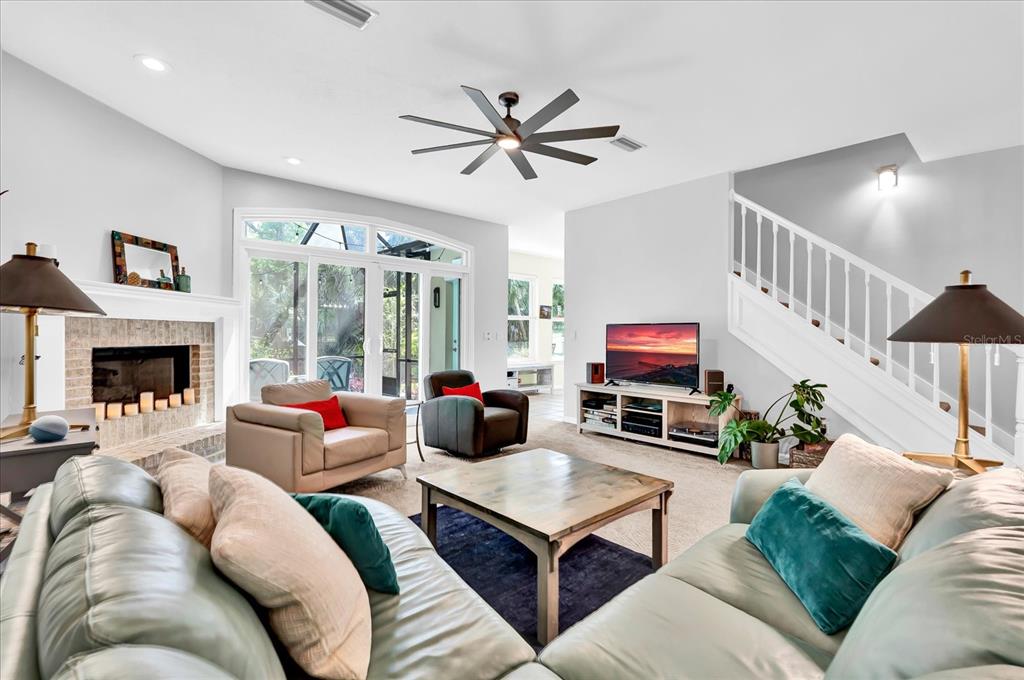 2 Bulow's Landing Flagler Beach, FL 32136 - Photo 7 of 42 a living room with furniture ceiling fan and a fireplace