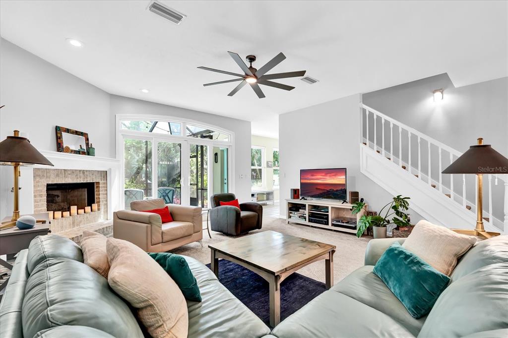 2 Bulow's Landing Flagler Beach, FL 32136 - Photo 8 of 42 a living room with furniture a fireplace and a chandelier