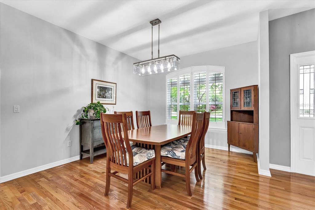 2 Bulow's Landing Flagler Beach, FL 32136 - Photo 9 of 42 a dining room with furniture a chandelier and wooden floor