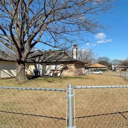 a view of a yard with snow on the road