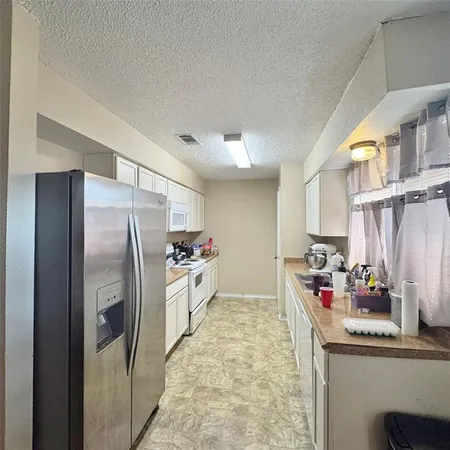 a kitchen with refrigerator and window