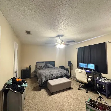 a bedroom with furniture and a gym equipment