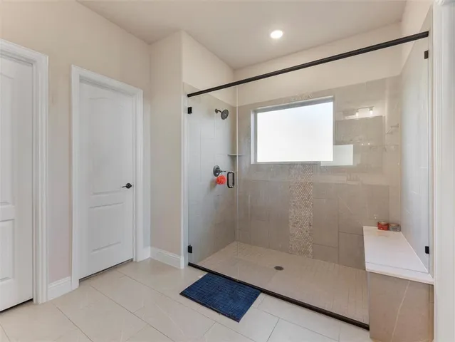 a spacious bathroom with a double vanity sink a mirror and a bathtub
