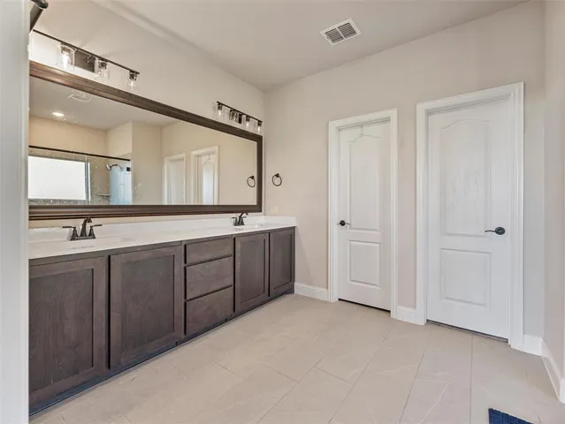 a spacious bedroom with a bed and a ceiling fan