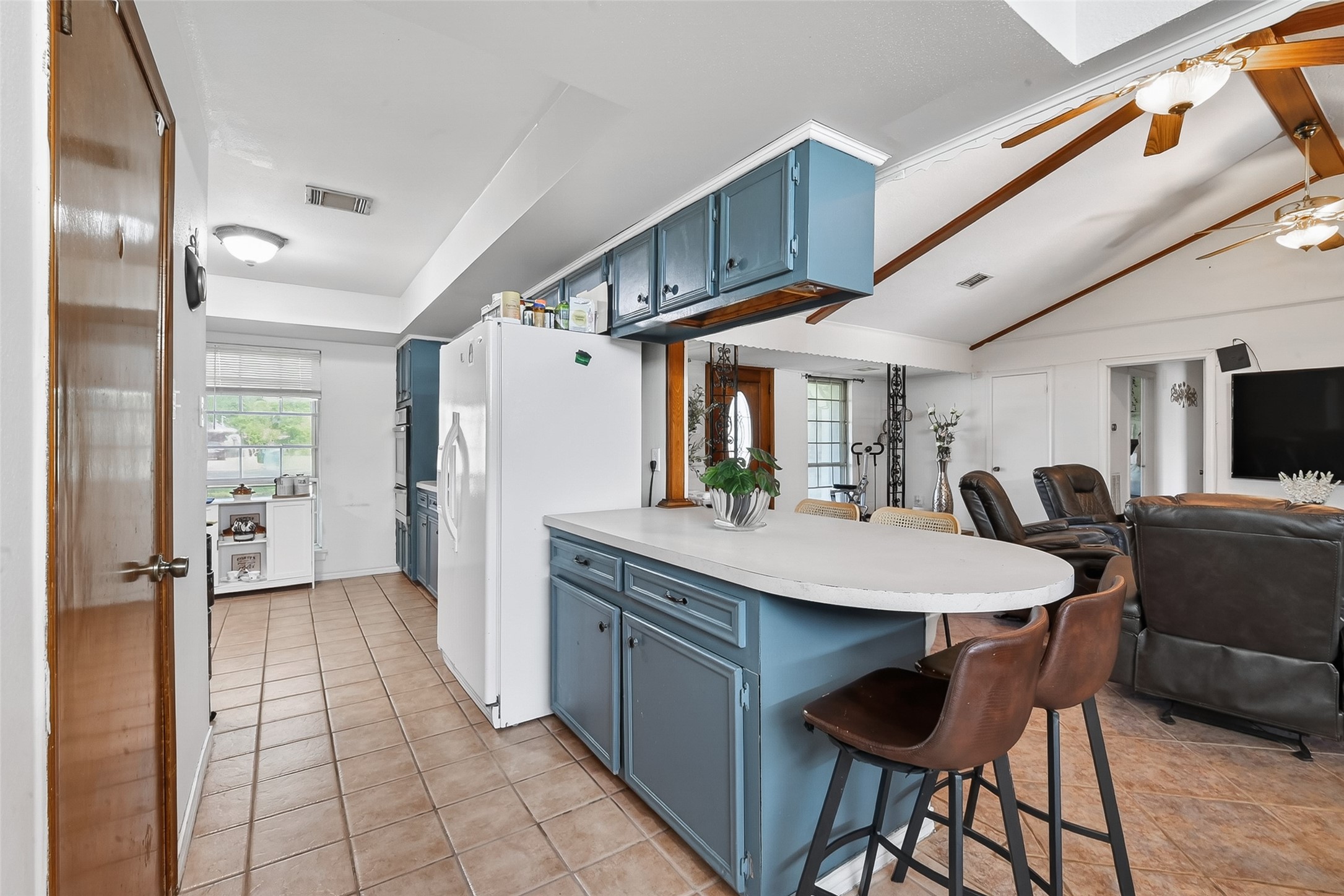 621 Elsbeth Road Channelview, TX 77530 - Photo 11 of 38 a kitchen with stainless steel appliances kitchen island granite countertop a table chairs and a refrigerator