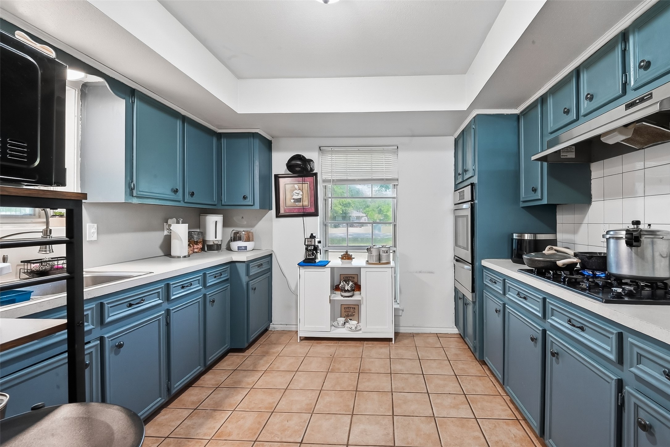 621 Elsbeth Road Channelview, TX 77530 - Photo 2 of 38 a kitchen with a sink a stove top oven a refrigerator and cabinets