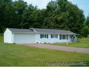 7 Indian Spring Road Tunkhannock, PA 18657 - Photo 1 of 4 a front view of a house with a garden