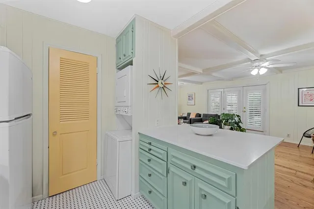 a view of a kitchen cabinets a sink and a refrigerator