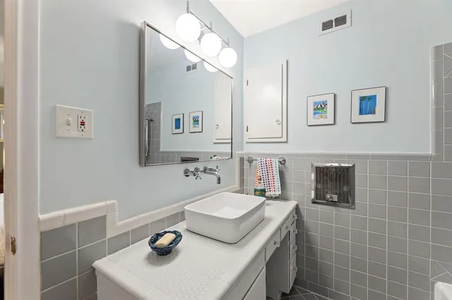 a bathroom with a sink toilet and mirror