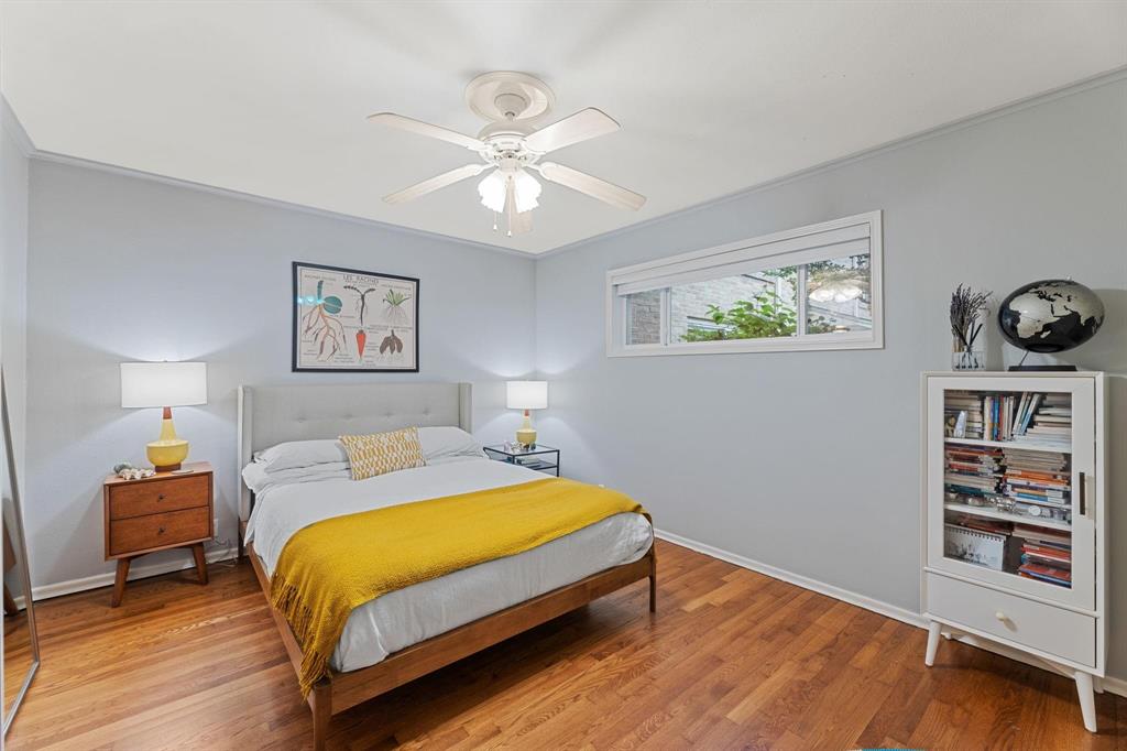 6135 Bandera Avenue, Unit A Dallas, TX 75225 - Photo 17 of 24 a bedroom with a bed and a bookshelf
