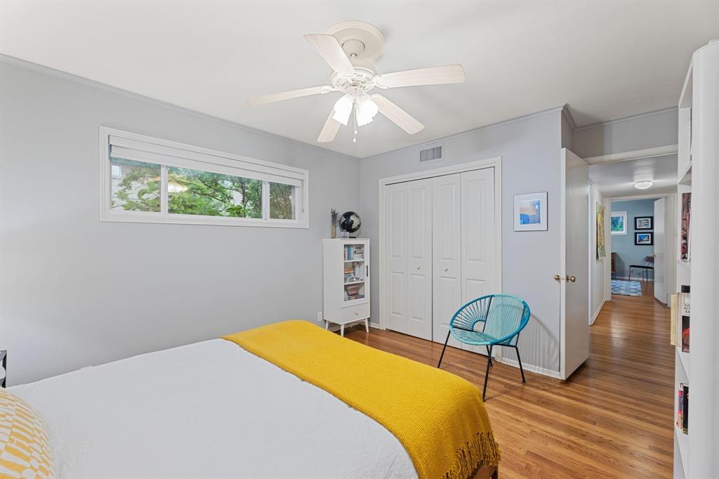 6135 Bandera Avenue, Unit A Dallas, TX 75225 - Photo 18 of 24 a bedroom with a bed and wooden floor