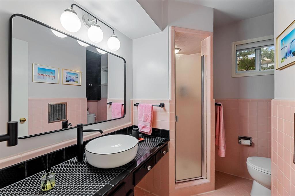 6135 Bandera Avenue, Unit A Dallas, TX 75225 - Photo 19 of 24 a bathroom with a sink a toilet and a mirror