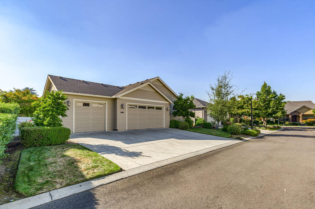 1034 Buck Point Street Central Point, OR 97502 - Photo 11 of 43 a front view of a house with a yard and garage