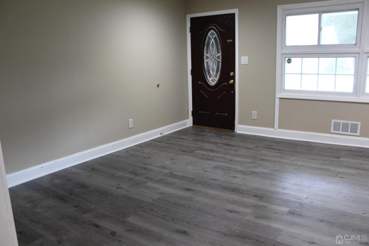 27 Markham Road Edison, NJ 08817 - Photo 13 of 28 an empty room with wooden floor and window