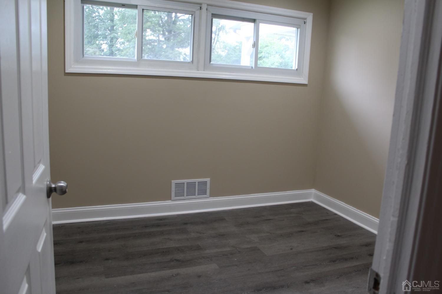 27 Markham Road Edison, NJ 08817 - Photo 14 of 28 an empty room with wooden floor and windows