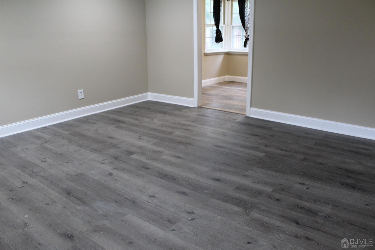 27 Markham Road Edison, NJ 08817 - Photo 18 of 28 a view of an empty room with wooden floor