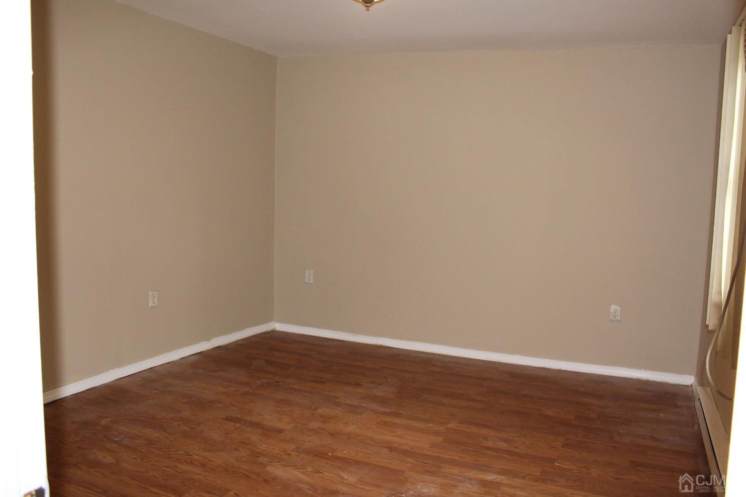 27 Markham Road Edison, NJ 08817 - Photo 20 of 28 a view of an empty room with wooden floor