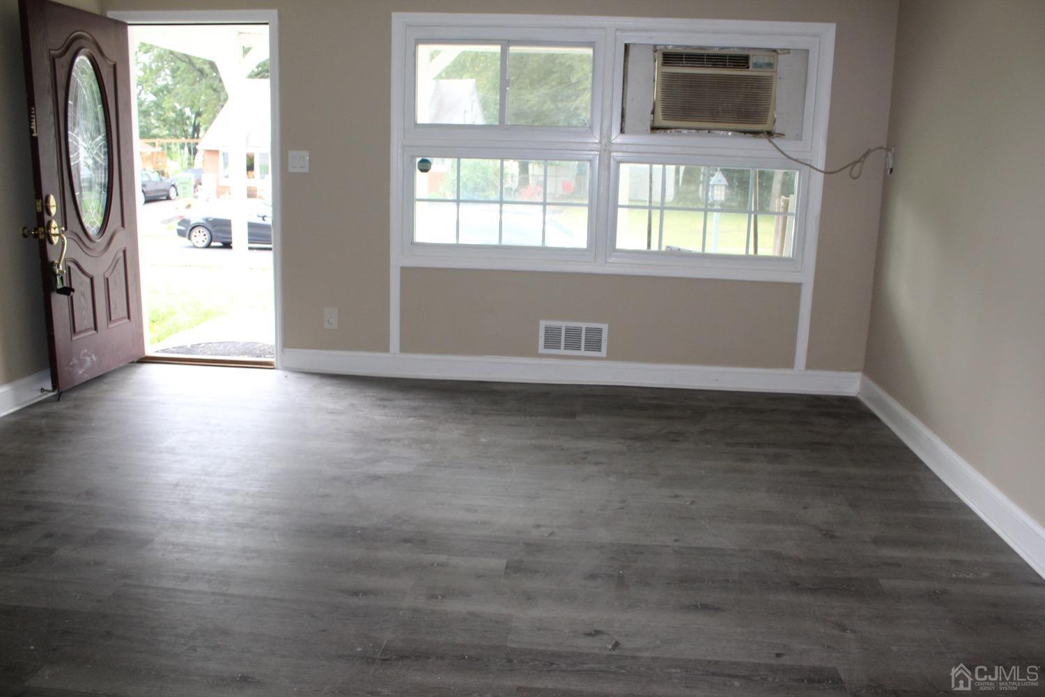 27 Markham Road Edison, NJ 08817 - Photo 2 of 28 an empty room with wooden floor and windows