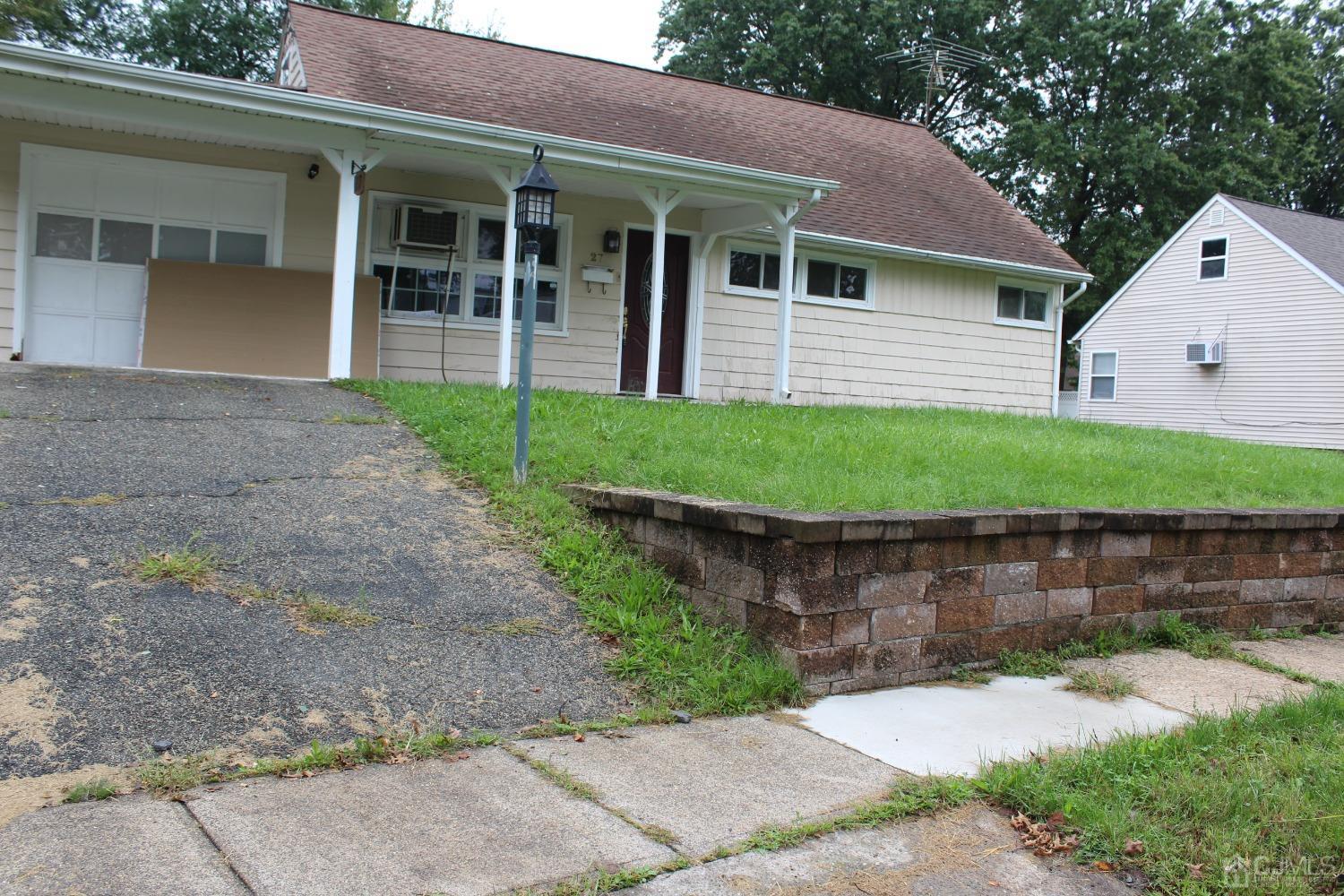 27 Markham Road Edison, NJ 08817 - Photo 24 of 28 front view of a house with a garden