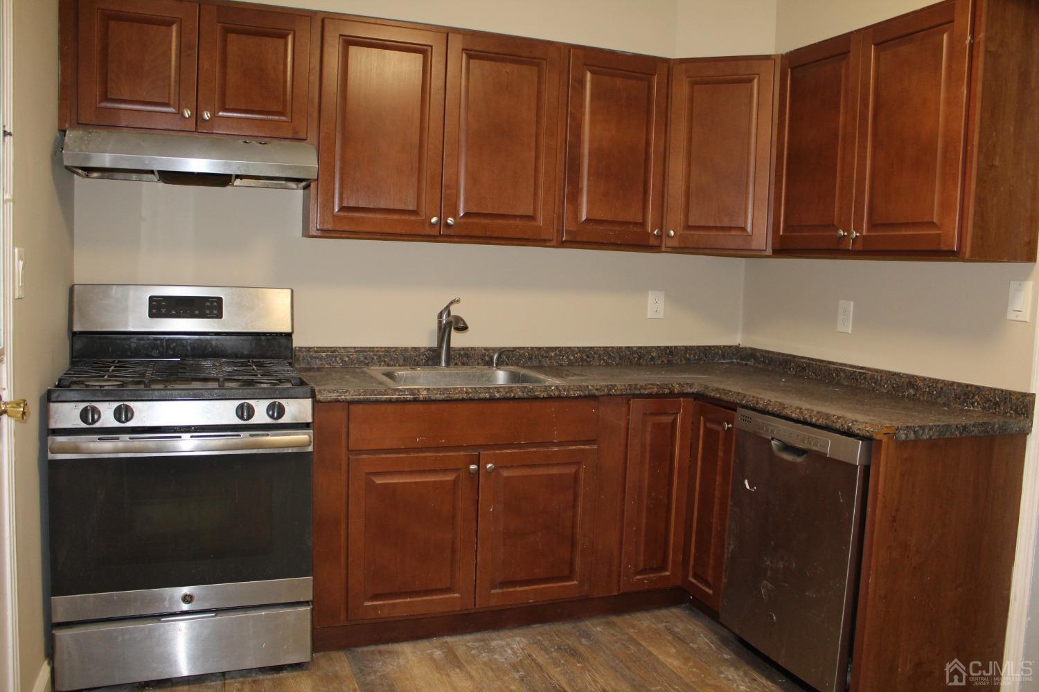 27 Markham Road Edison, NJ 08817 - Photo 4 of 28 a kitchen with stainless steel appliances granite countertop a sink stove and cabinets